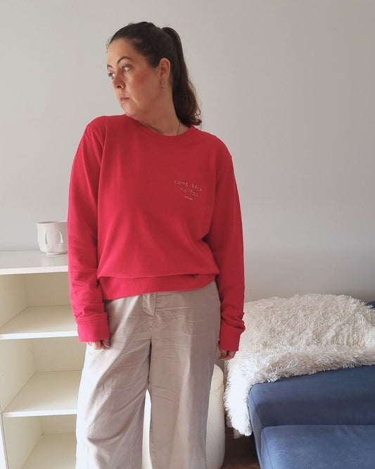 Unisex COME BACK TO YOU Blend Sweater in red with off-white print, minimalist sustainable design by Miss Piggy.