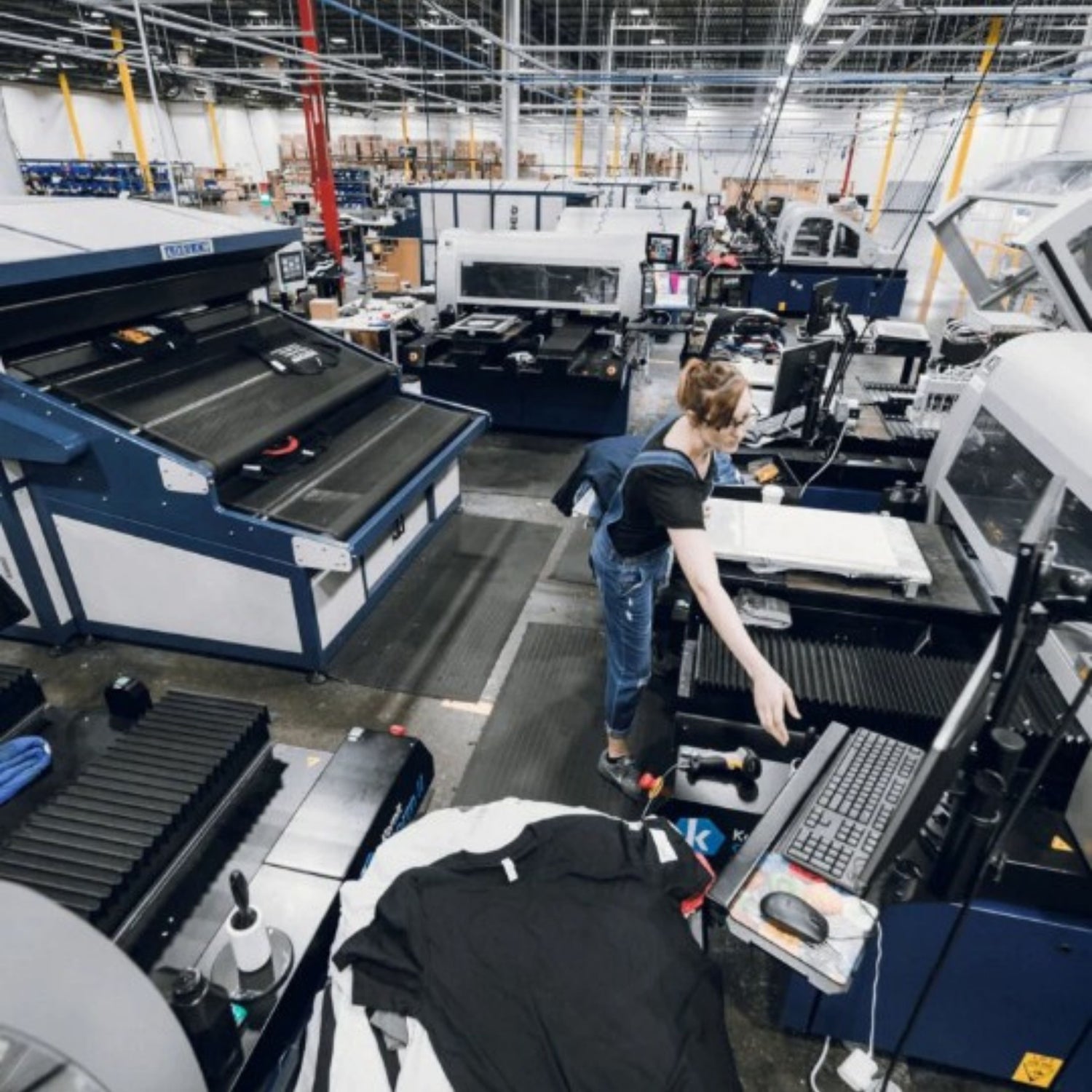 Person working in a factory setting with machinery and equipment.