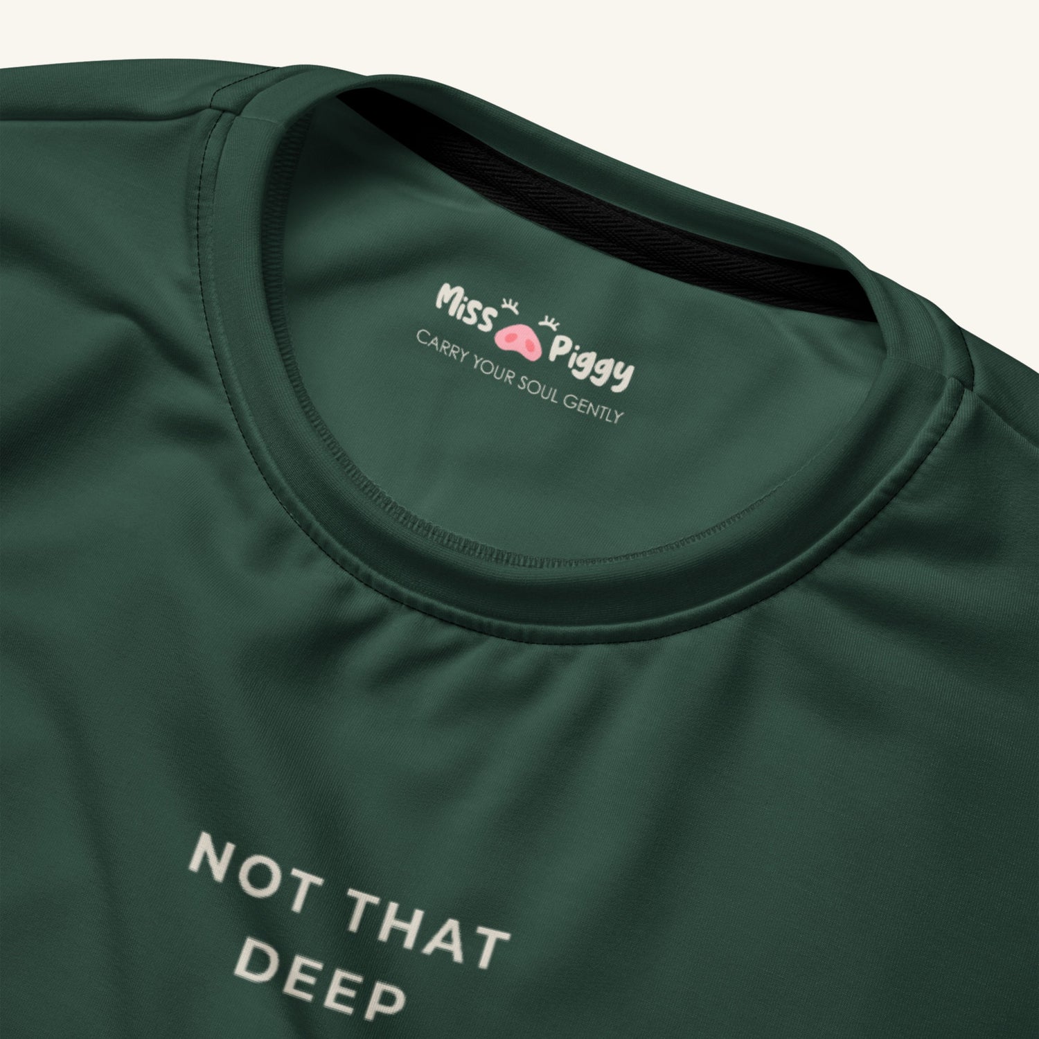 Green t-shirt with 'Miss Piggy' logo and text on a white background