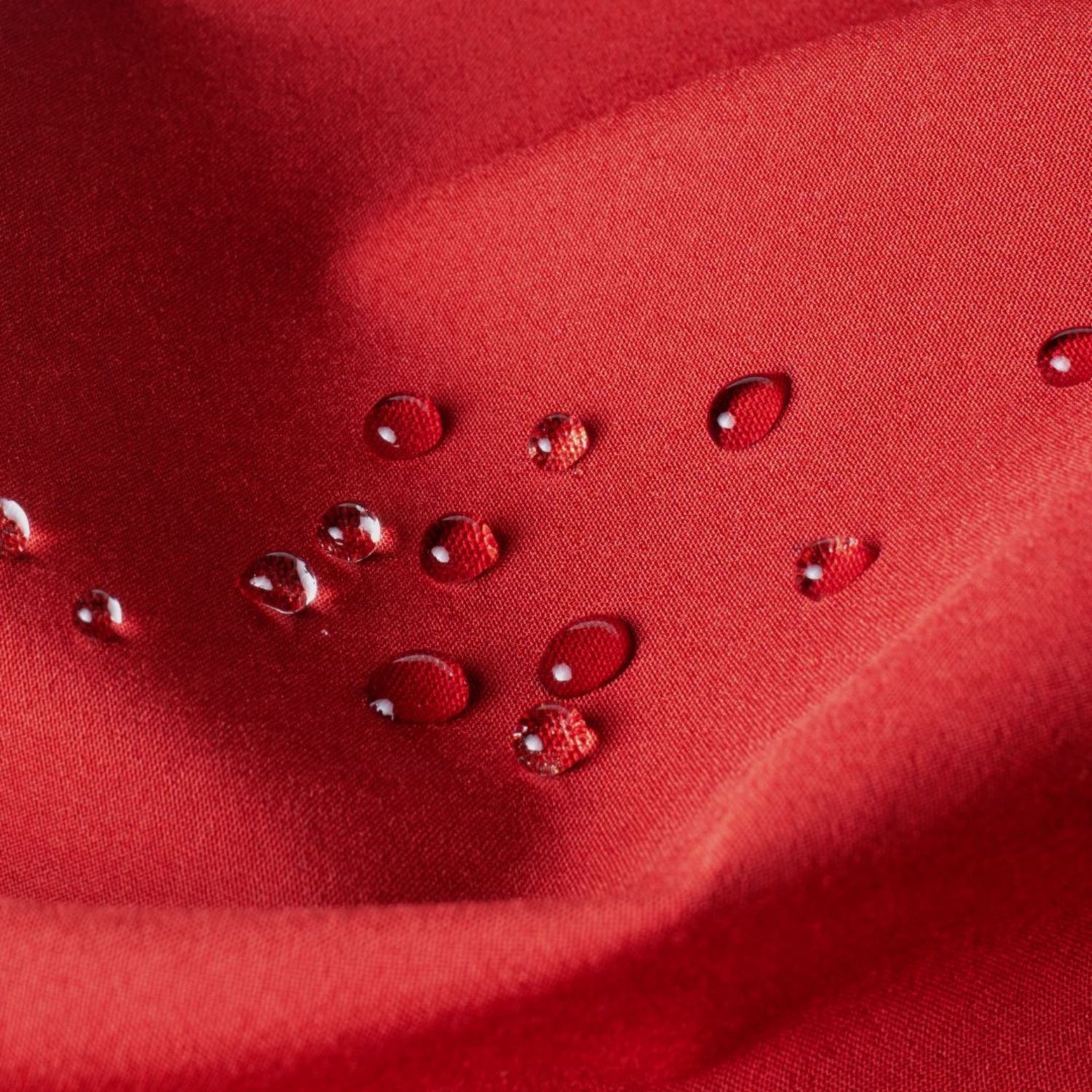 Red fabric with water droplets on a close-up view