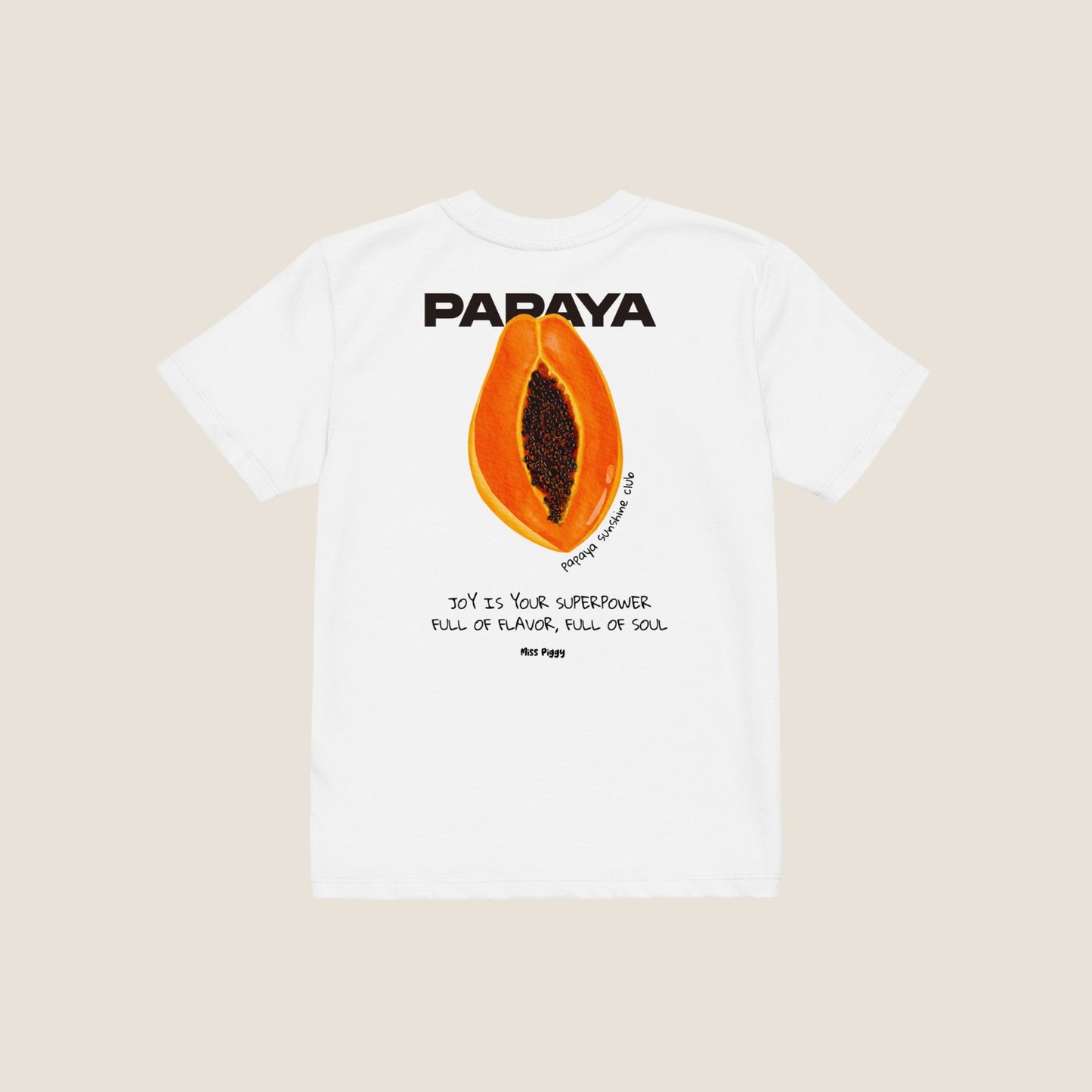 Child wearing the PAPAYA t-shirt in white. Unisex organic cotton design with soft texture and playful energy, shown in a light and joyful setting.