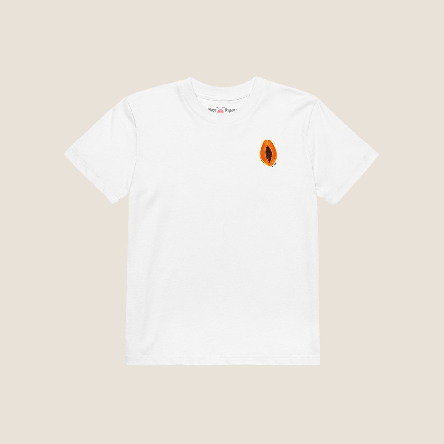 Child wearing the PAPAYA t-shirt in white. Unisex organic cotton design with soft texture and playful energy, shown in a light and joyful setting.