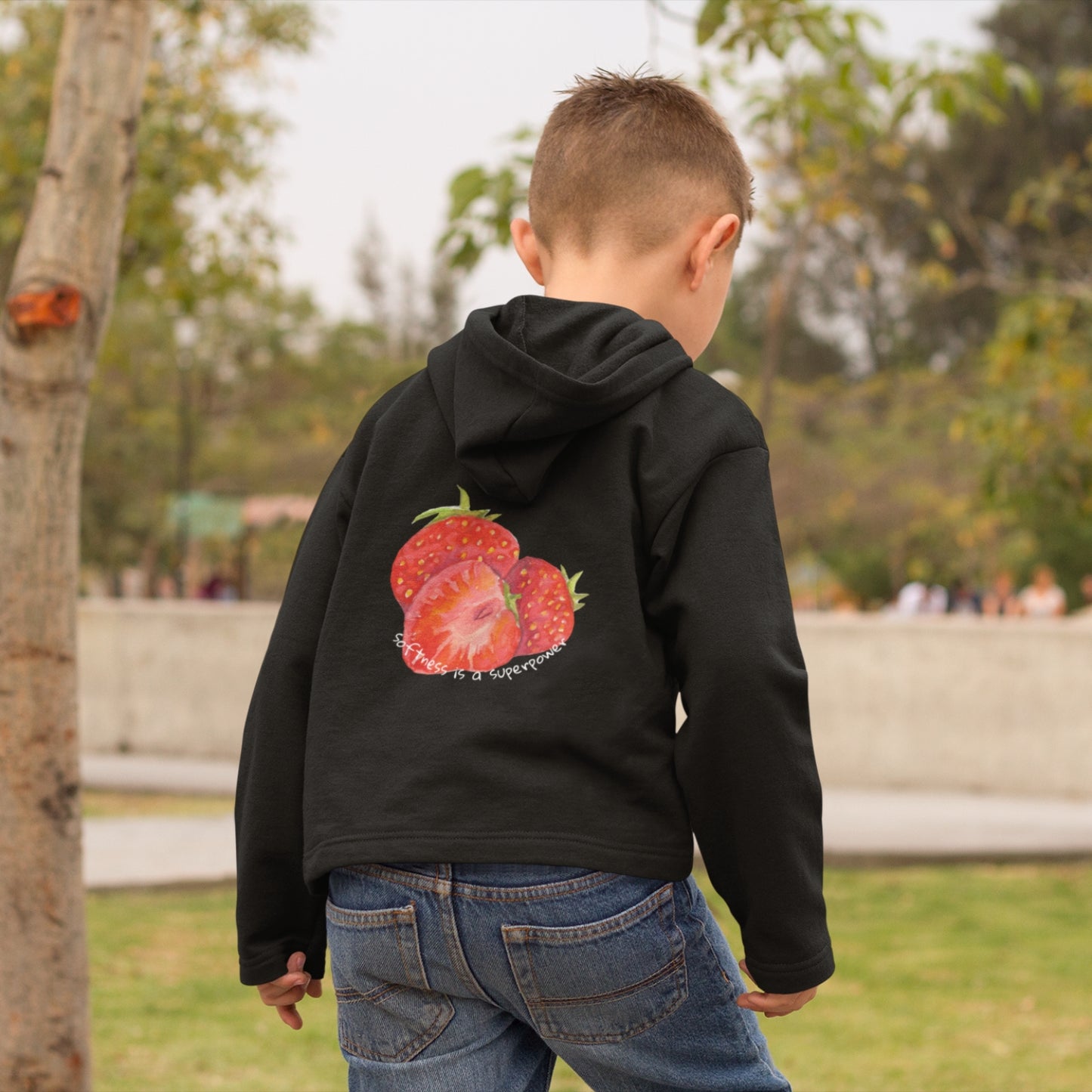 Child wearing the SOUL SNUG hoodie in a relaxed fit, made from organic cotton and recycled polyester. Unisex design with soft texture and natural tone, photographed against a light, playful background