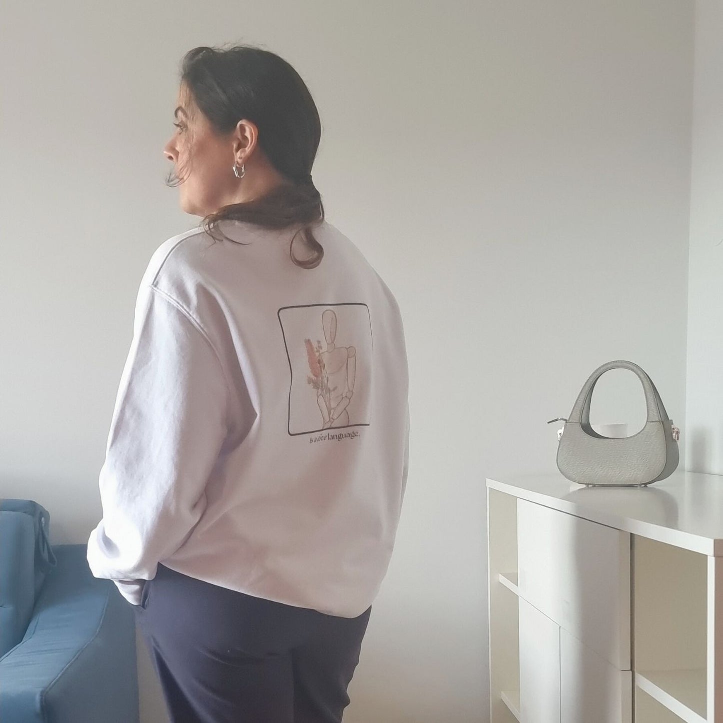 Unisex CONSISTENCY Organic Sweater in white with green print, minimalist sustainable design by Miss Piggy.