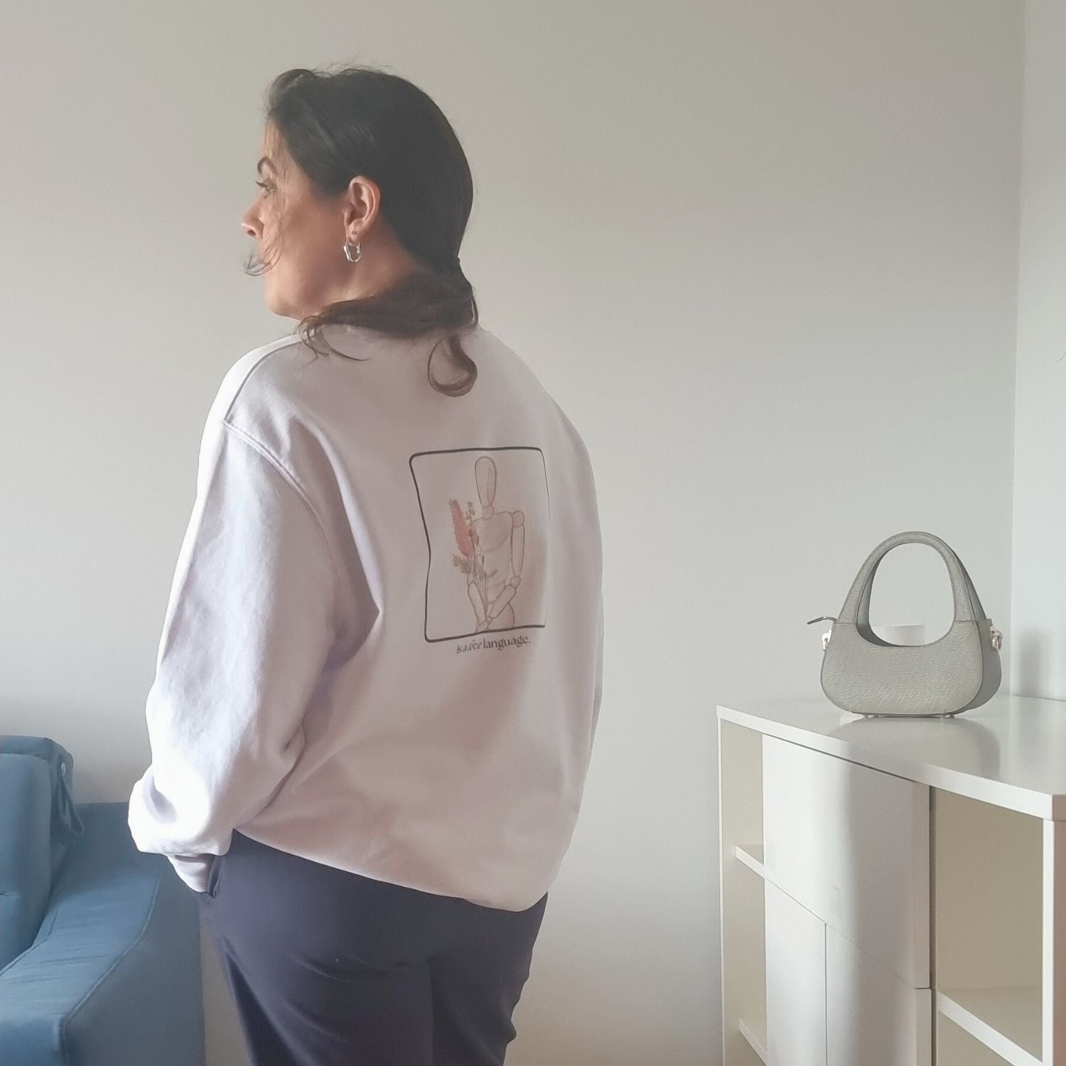 Unisex CONSISTENCY Organic Sweater in white with green print, minimalist sustainable design by Miss Piggy.