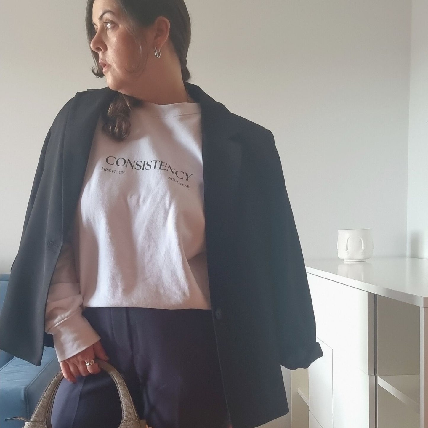 Unisex CONSISTENCY Organic Sweater in white with green print, minimalist sustainable design by Miss Piggy.