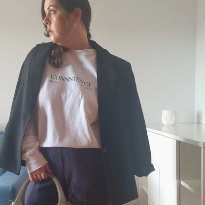 Unisex CONSISTENCY Organic Sweater in white with green print, minimalist sustainable design by Miss Piggy.