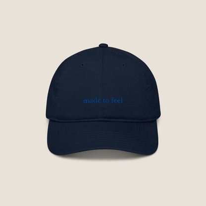 Navy blue cap with 'made to feel' text 