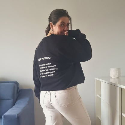 Unisex PROTOCOL Organic Sweater in black with white print, minimalist sustainable design by Miss Piggy.