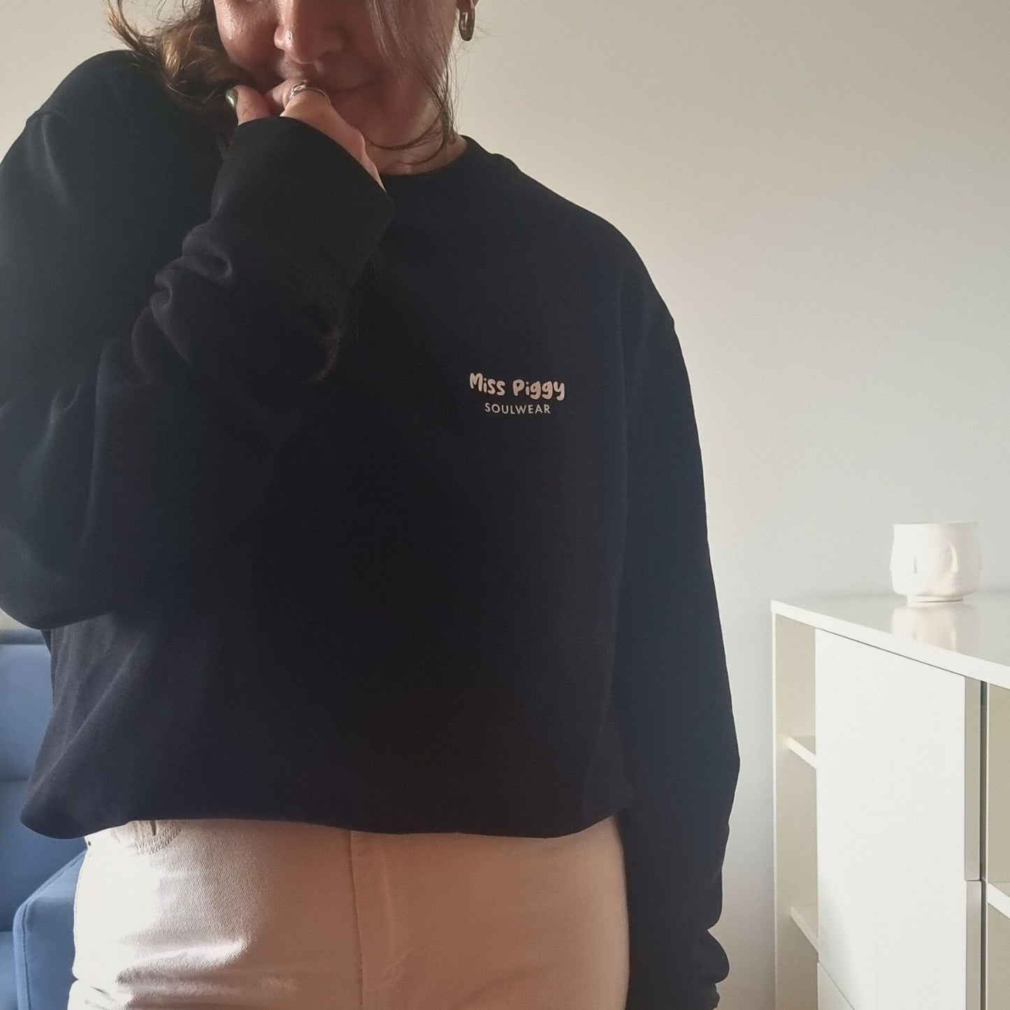 Unisex PROTOCOL Organic Sweater in black with white print, minimalist sustainable design by Miss Piggy.