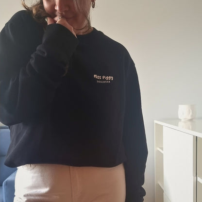 Unisex PROTOCOL Organic Sweater in black with white print, minimalist sustainable design by Miss Piggy.