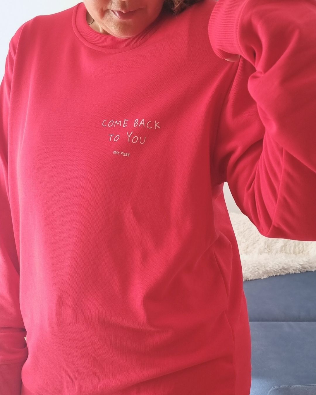 Unisex COME BACK TO YOU Blend Sweater in red with off-white print, minimalist sustainable design by Miss Piggy.