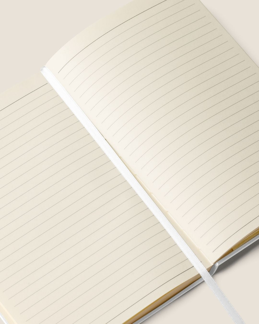 A durable Notebook UltraHyde hardcover, 80 lined cream pages, a matching elastic closure, and a ribbon bookmark with motivational quote.