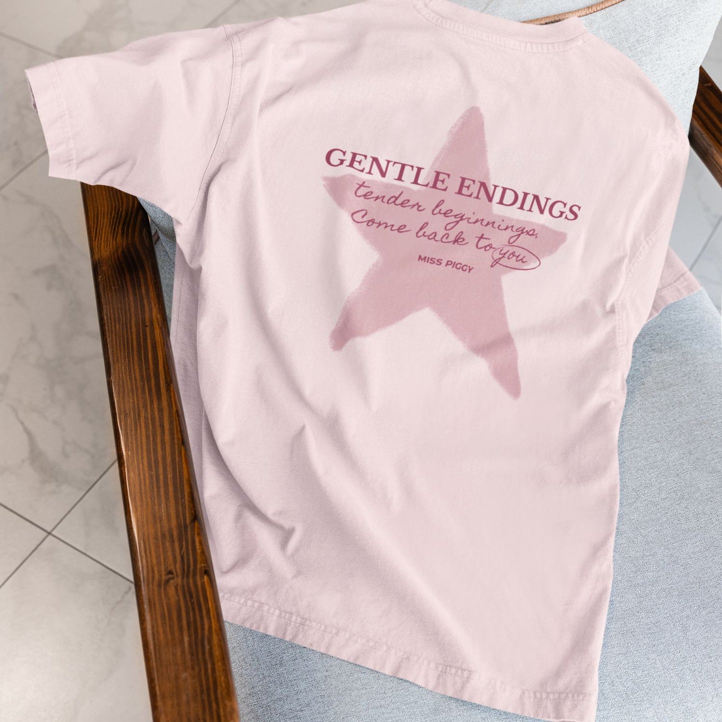 Gentle Endings Organic T-Shirt in cotton pink with small lipstick pink print in front  and featuring in back a star illustration and message.