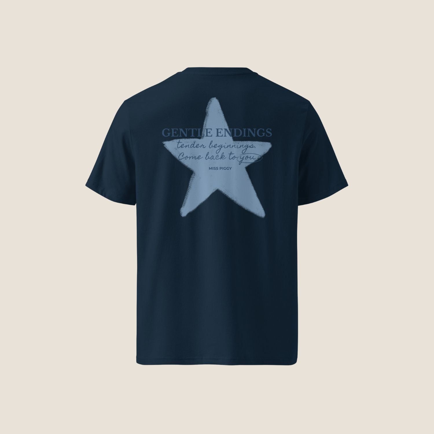 Gentle Endings Organic T-Shirt in navy with small blue print in front  and featuring in back a star illustration and message.