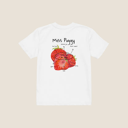 Two kids wearing the JUICY t-shirt in white. Unisex organic cotton design with soft texture and playful energy, shown in a light and joyful setting.