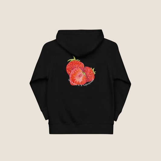 Child wearing the SOUL SNUG hoodie in a relaxed fit, made from organic cotton and recycled polyester. Unisex design with soft texture and natural tone, photographed against a light, playful background